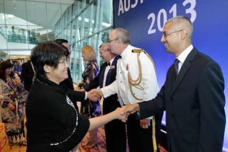 Staff of the Australian High Commission (on the right in front of the backdrop) greeting guests as they arrive for the Australia Day 2013 reception.